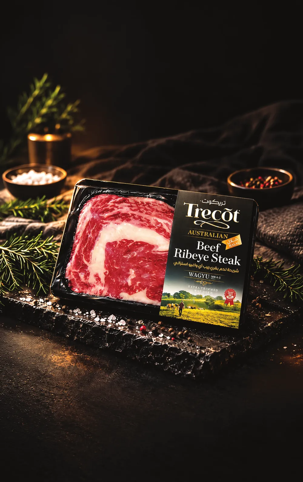 Trecõt Australian Wagyu Beef Ribeye Steak pack on a dark slate board with herbs
